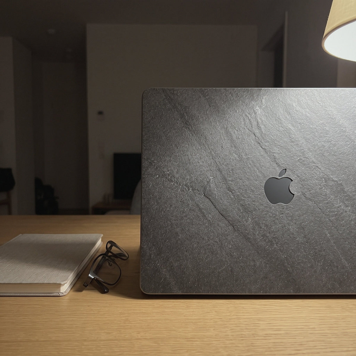 Real slate stone MacBook Pro 16-inch skin in Gunmetal, Cover-Up lifestyle shot on an evening desk