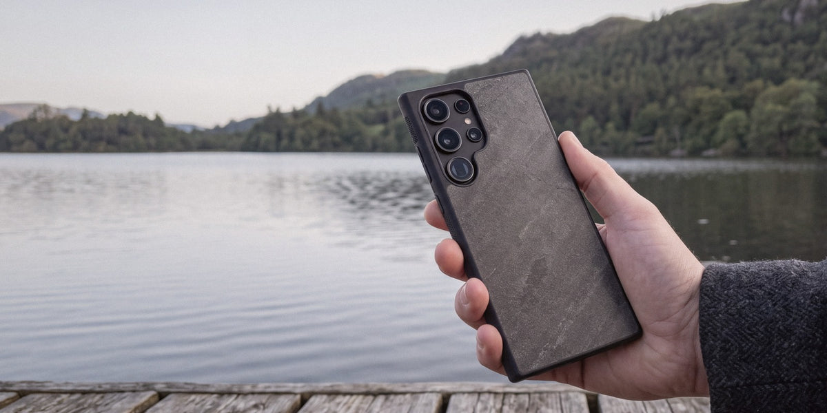 Gunmetal stone Samsung Galaxy case held beside a Lake District jetty