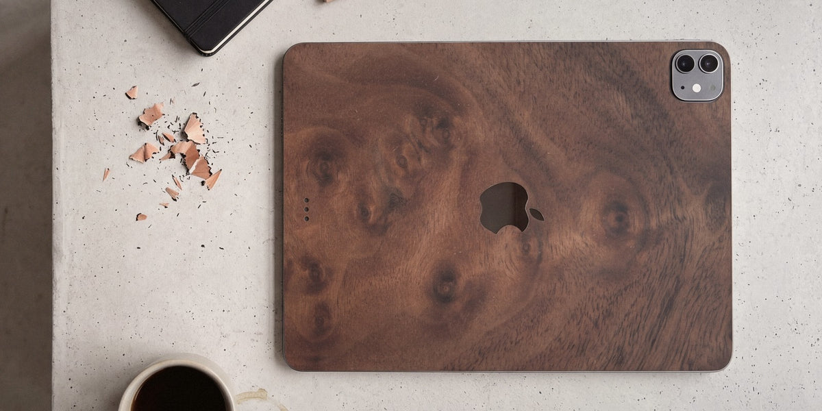 Walnut Burl wood iPad skin on a concrete desk