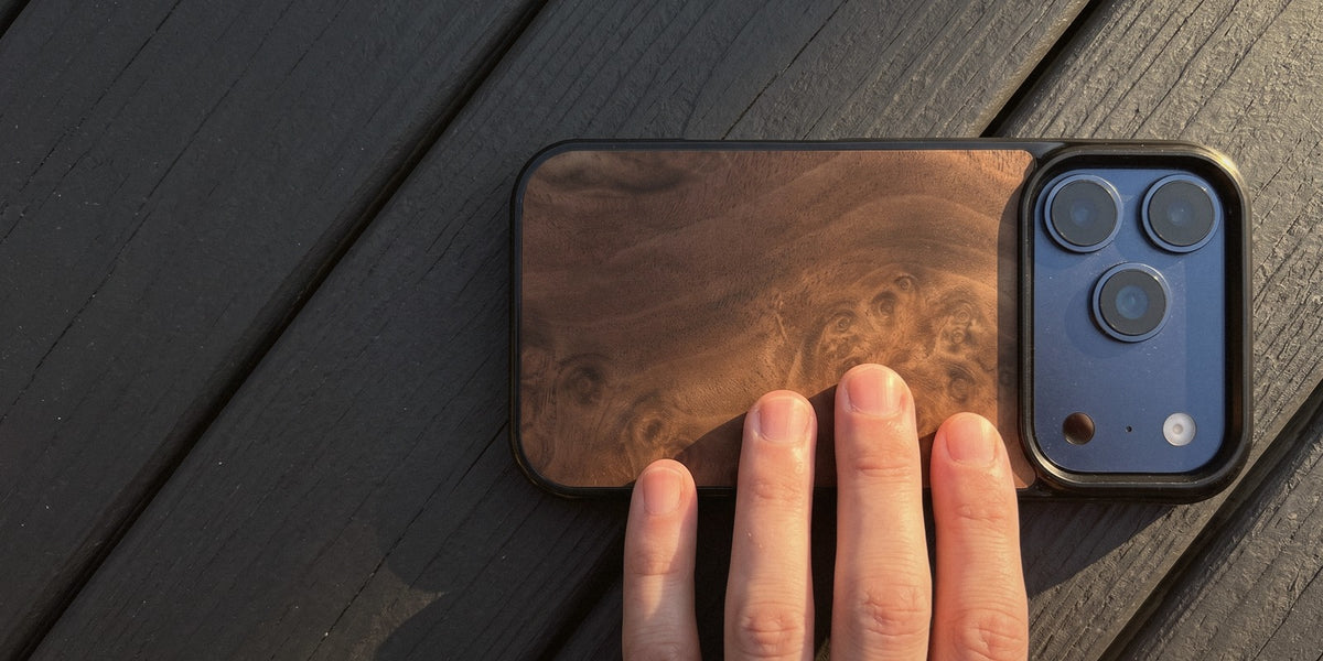 Walnut Burl wood iPhone case on weathered decking